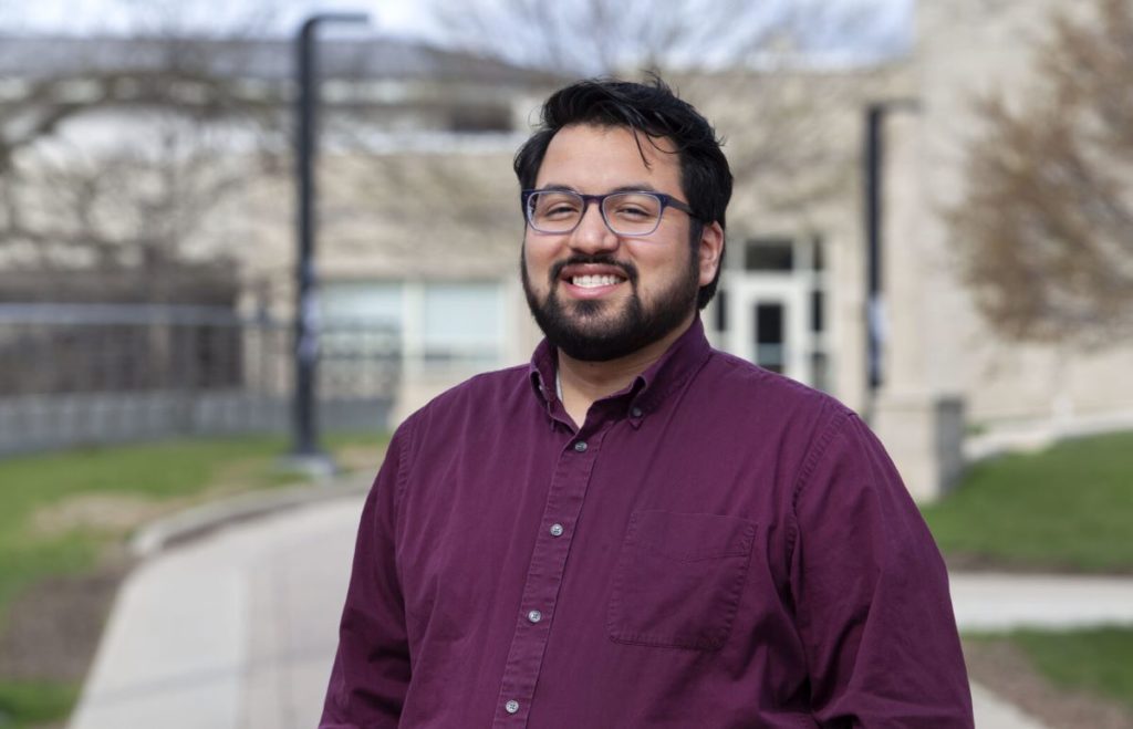Headshot of Jamie Gonzales with the Diversity Center in the background 
