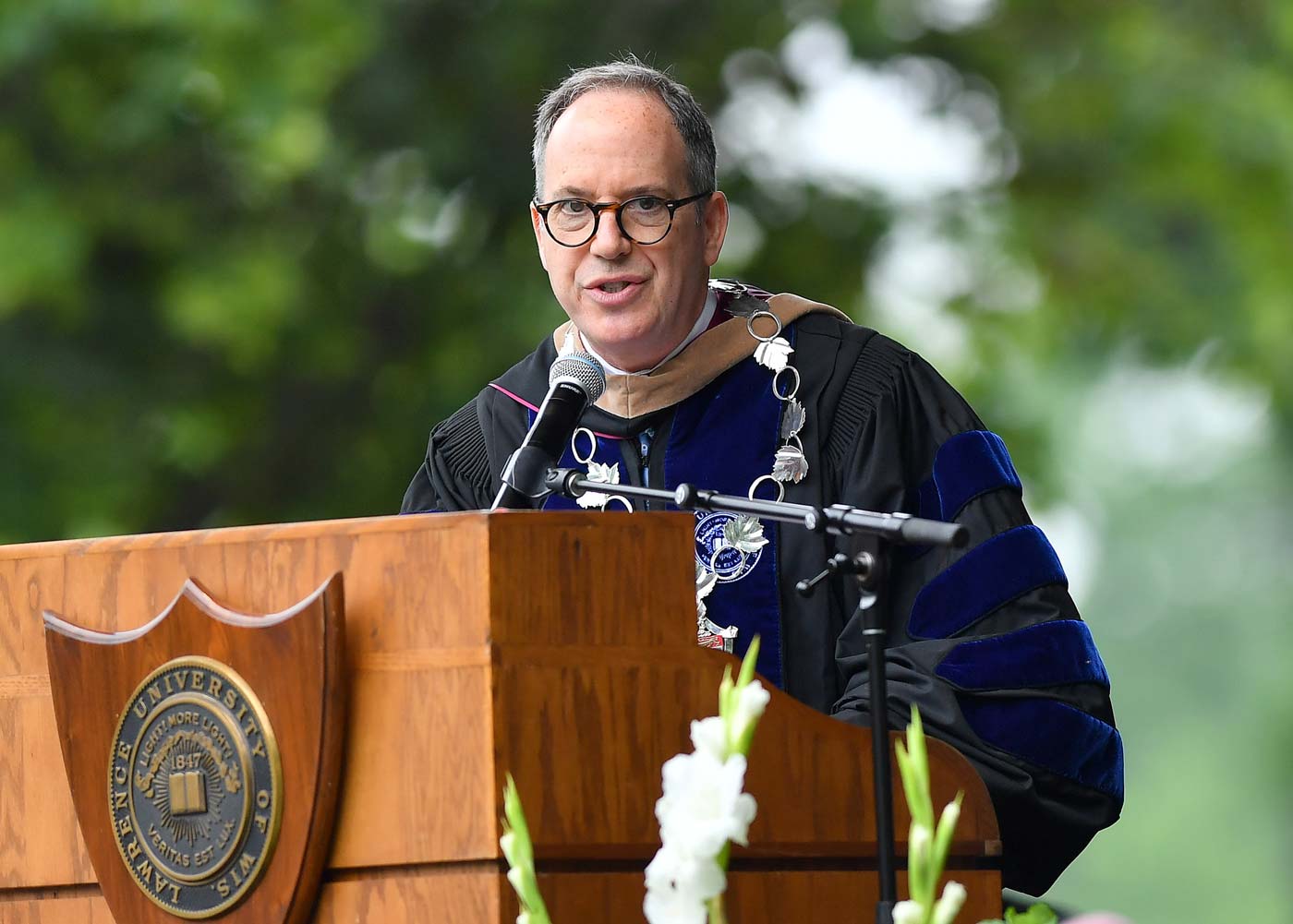 President Mark Burstein speaks at Commencement ceremony outdoors