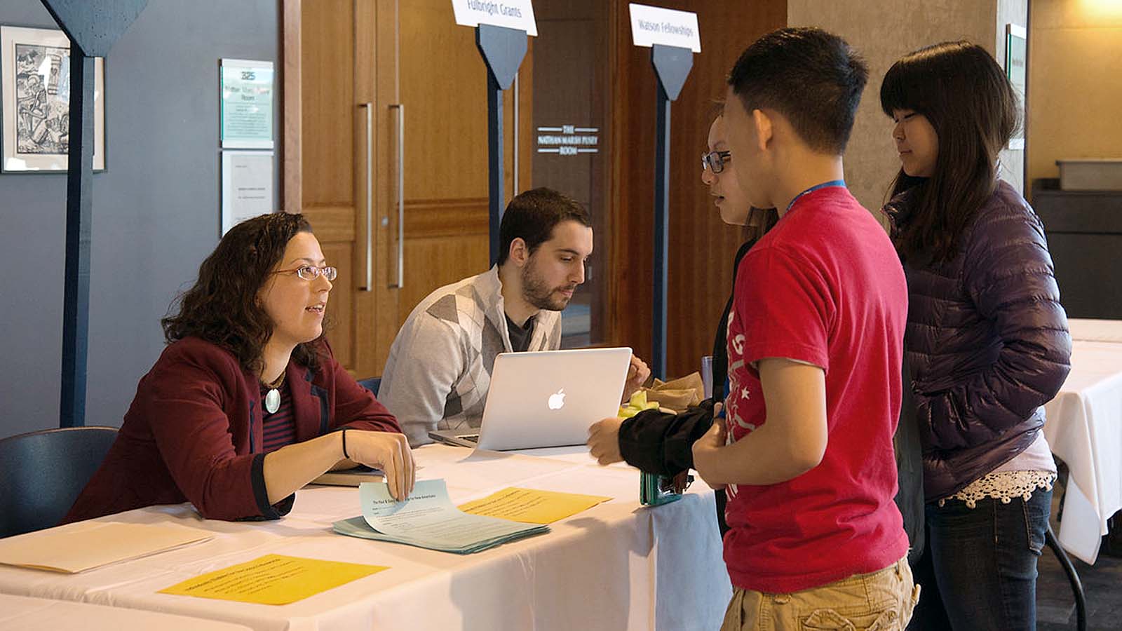 Students discussing fellowships and scholarships with staff