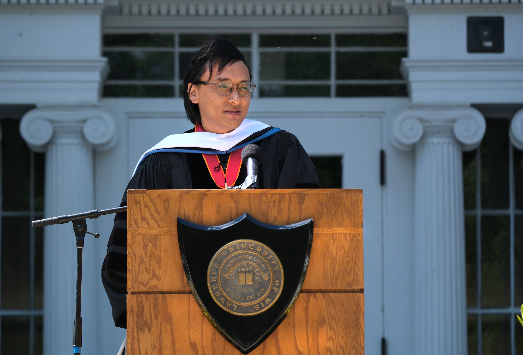 Pawo Choyning Dorji '06 speaks at the podium.