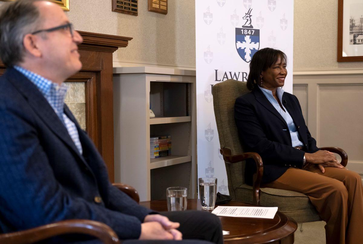 Mark Burstein and President Laurie Carter sitting next to each other as they smile for a picture
