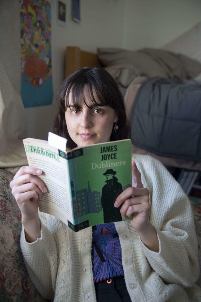 Isabella Mariani looks up from reading James Joyce's "Dubliners."