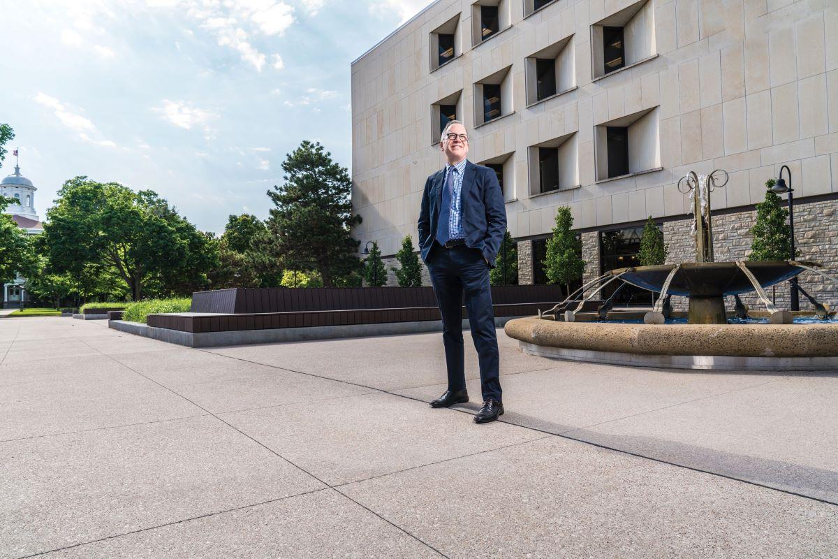 Hero shot of Mark Burstein next to the water fountain located near the Mudd library 