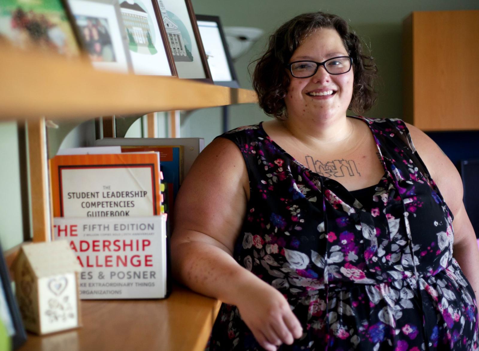 Rose Wasielewski posing next to a bookshelf