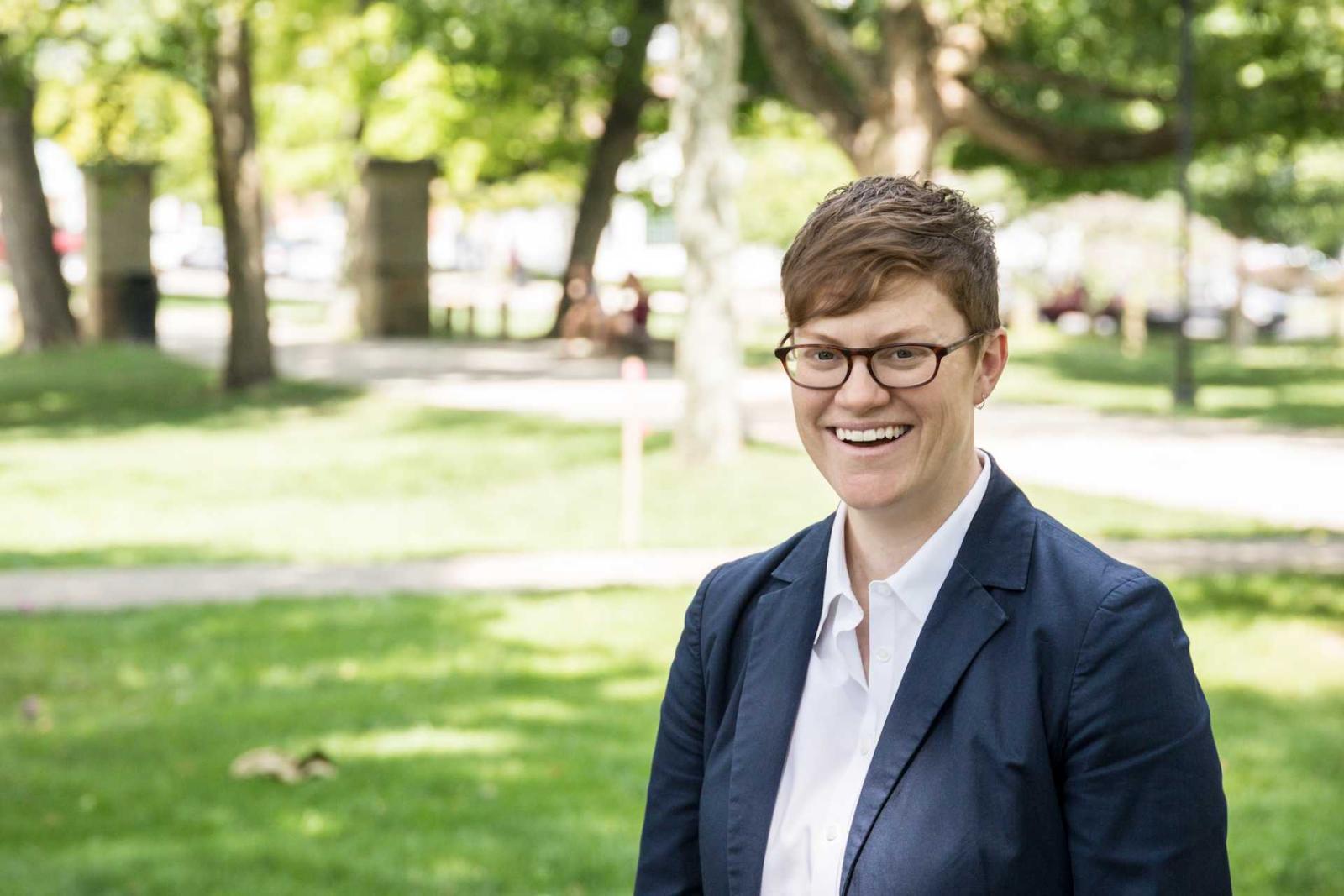 Robyn Bowers standing on green lawn with trees in background