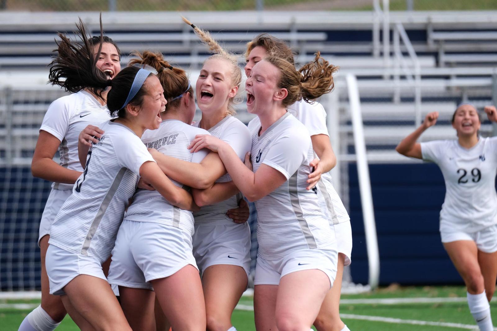 Teammates surround Lawrence University's Emma Vasconez after scoring a golden goal in overtime
