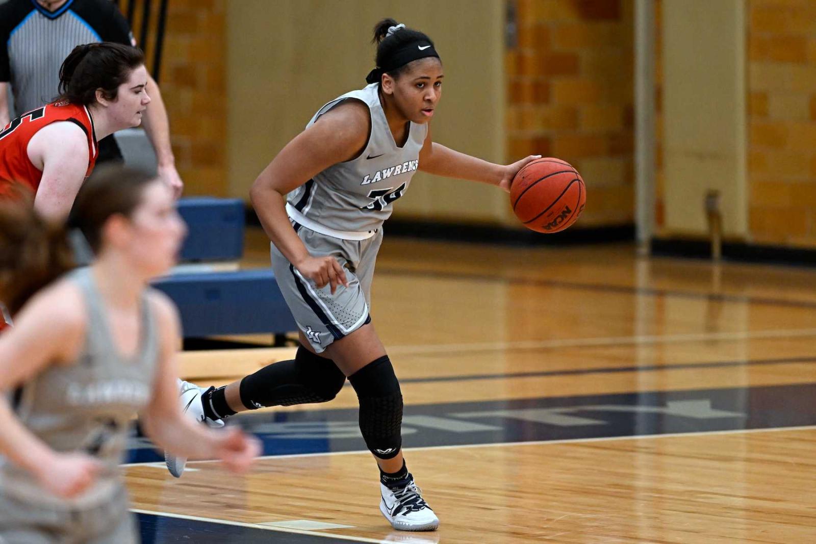 Kenya Earl dribbles the ball up court during Lawrence's Jan. 15 game against Grinnell.