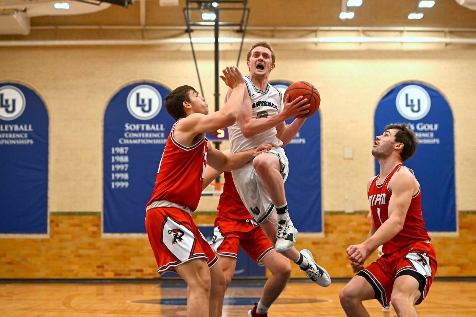 Brad Sendell drives to the basket amid three Ripon defenders.
