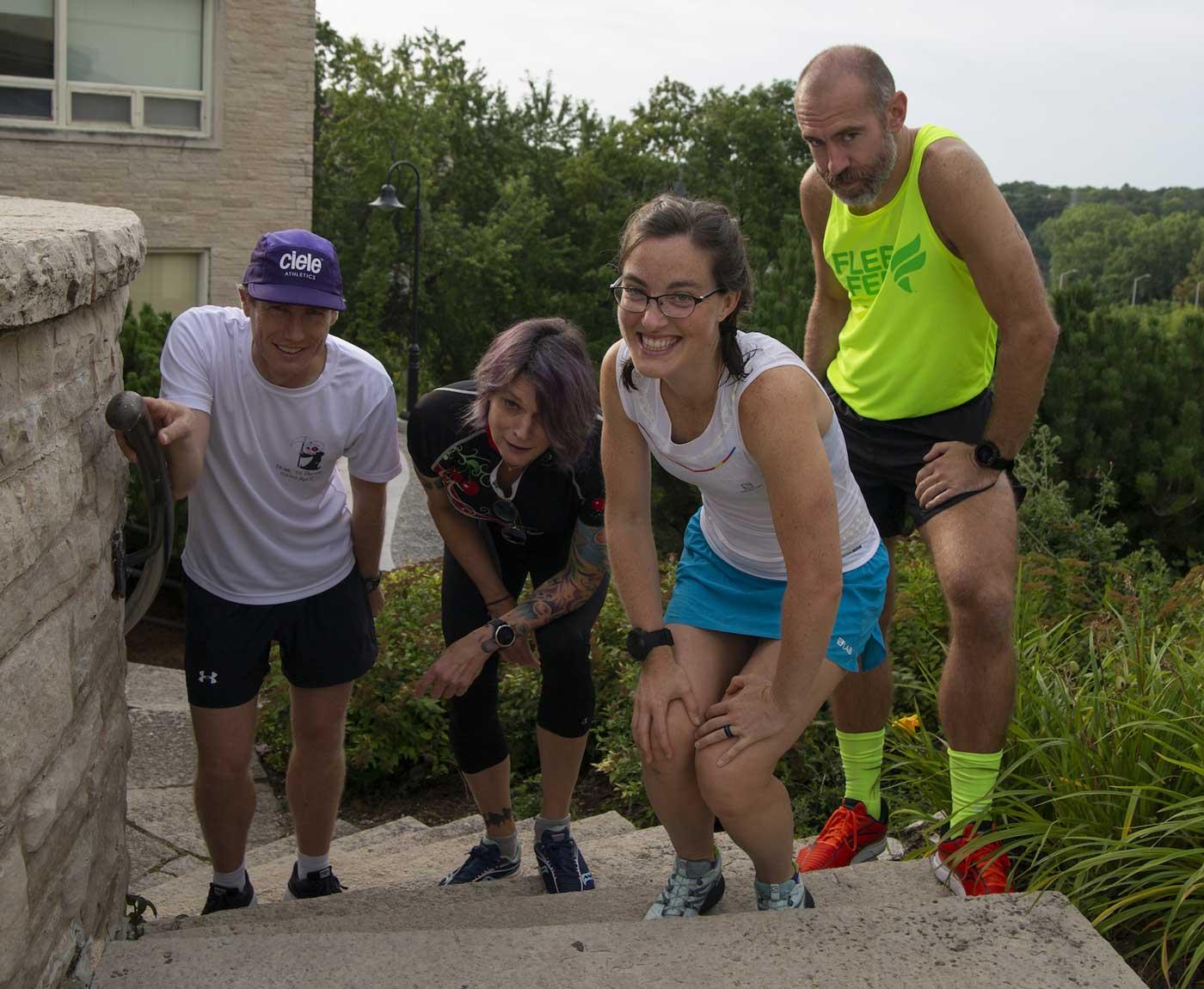 Four Lawrence faculty members posing for a photo while wearing running attire