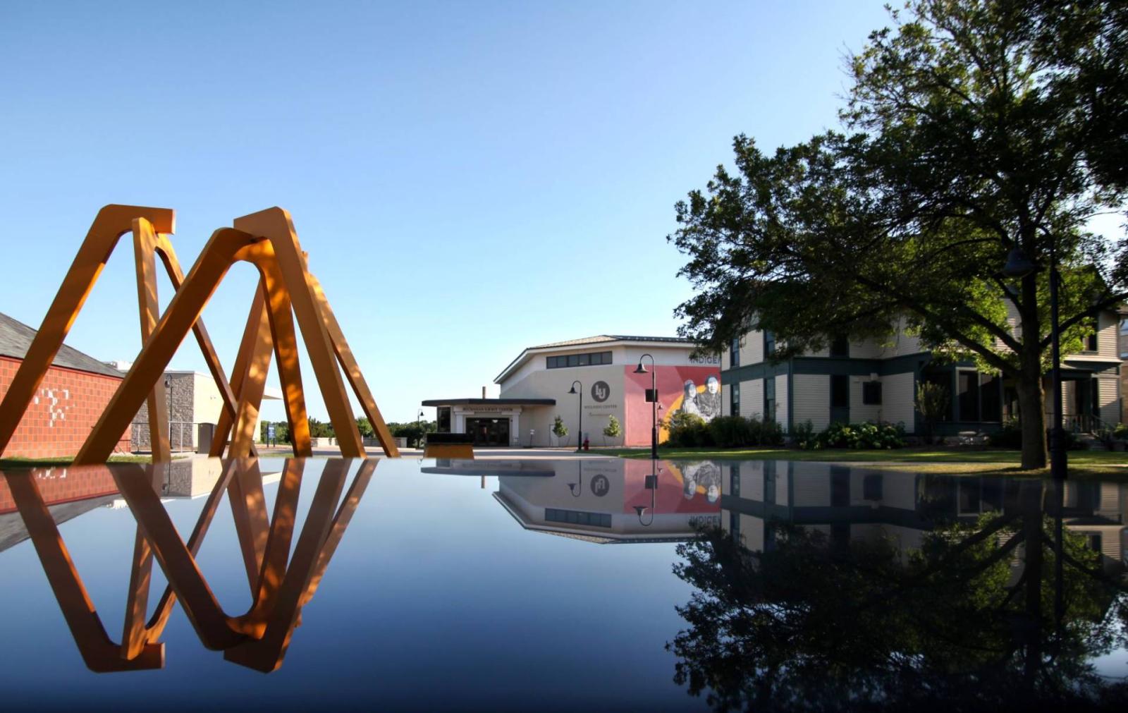 Aerial Landscape sculpture, the Wellness Center, and Sampson House reflected just before sunset.