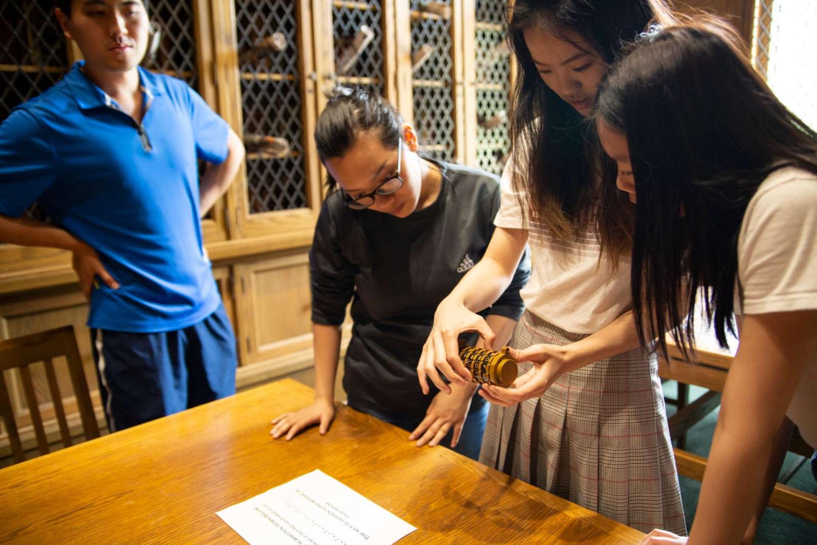 Students work to solve an escape room set up in the Mudd Library during spring term finals. 