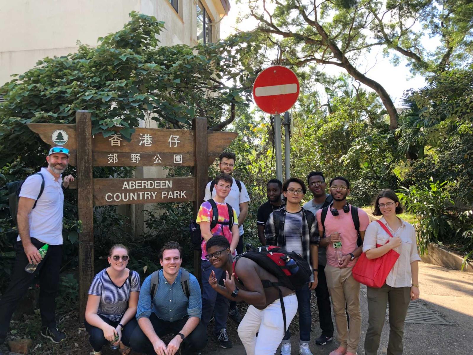 Lawrentians pose around "Aberdeen Country Park" sign in Hong Kong.