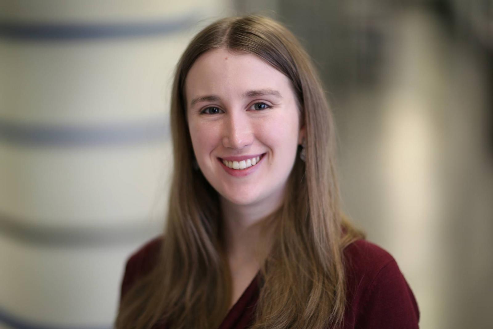 Headshot of Katherine Meckel against a blurred background.
