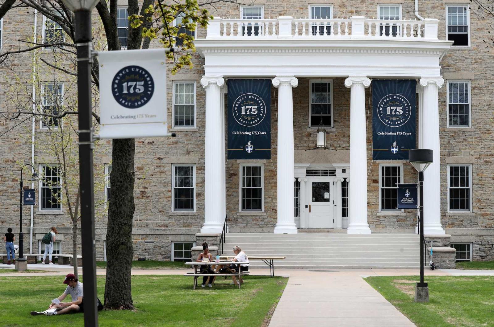 Students chat on the green in front of Main Hall, which is adorned with 175th anniversary banners.