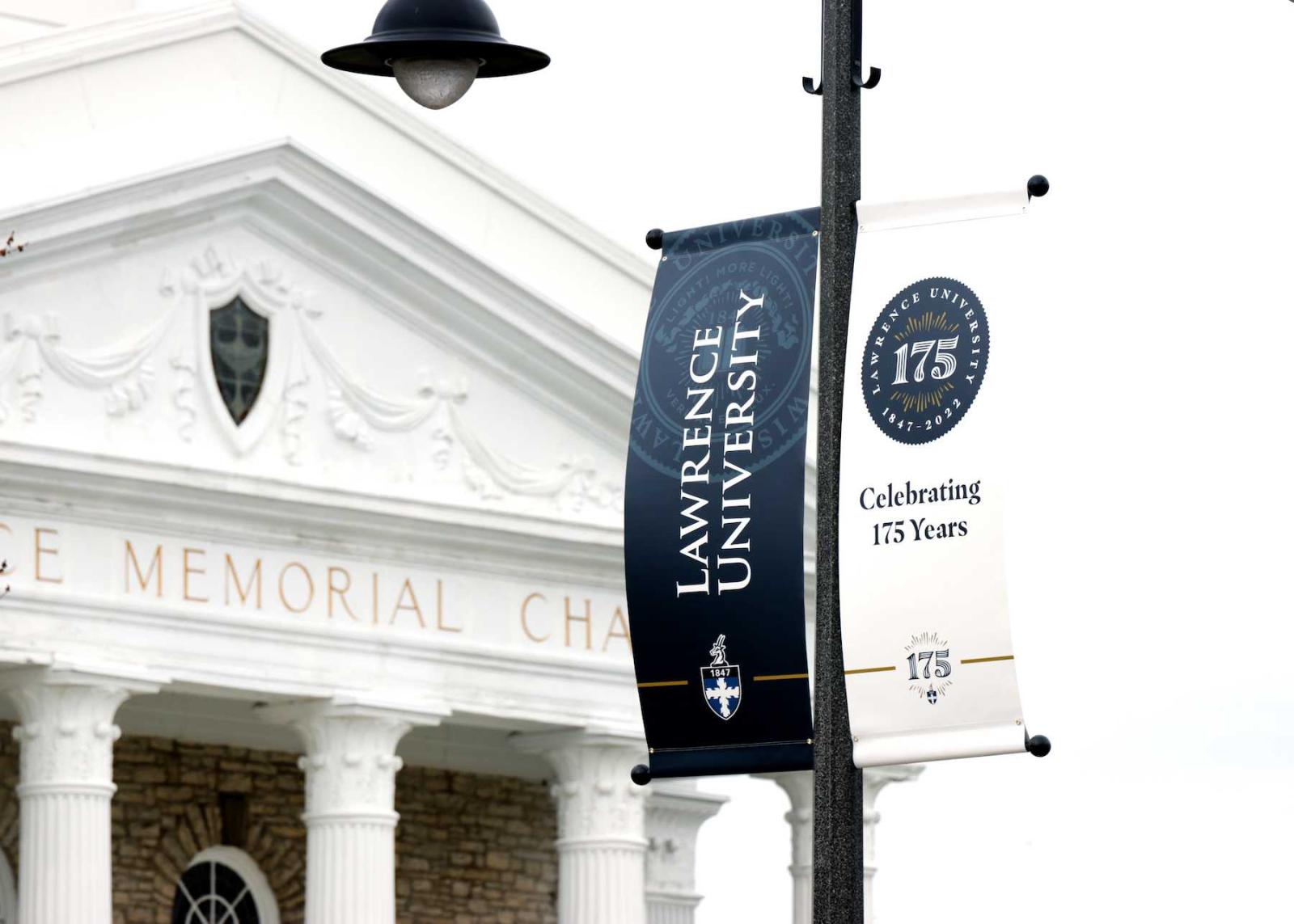 A banner celebrating Lawrence's 175 Years hangs on College Avenue with Memorial Chapel in the background.