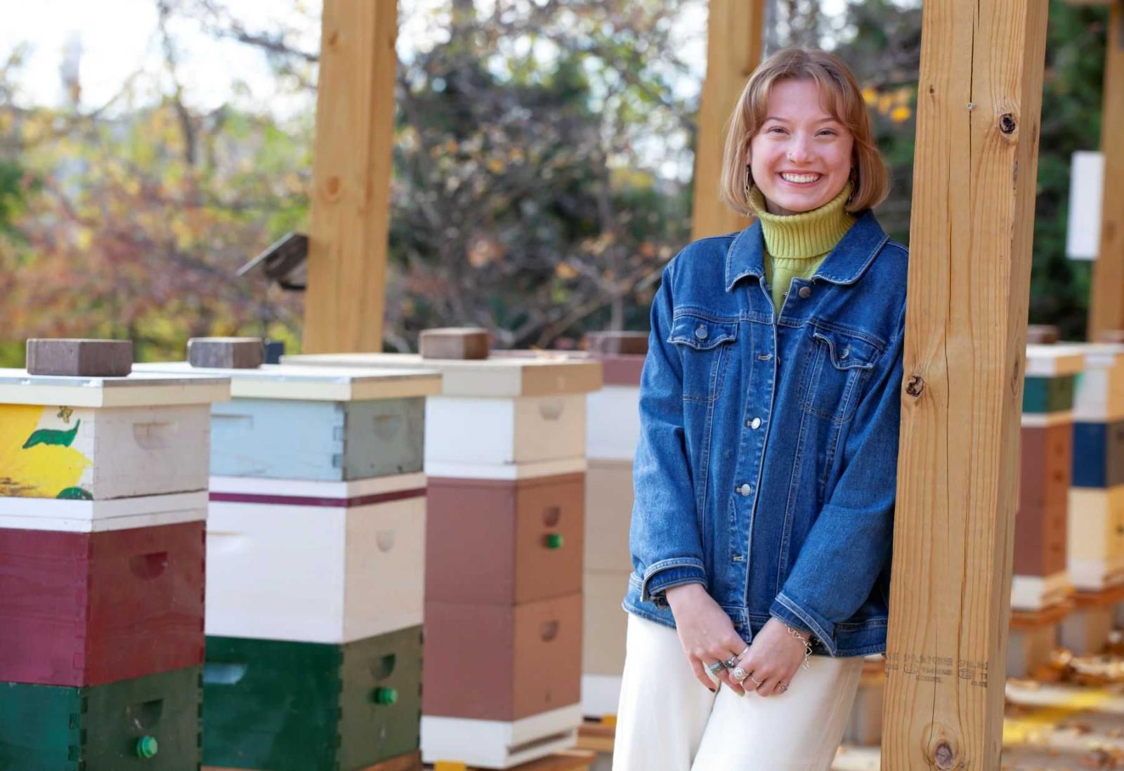 Biology major, Bella Goland poses for a photo in the apiary in Sustainable Lawrence University Garden.
