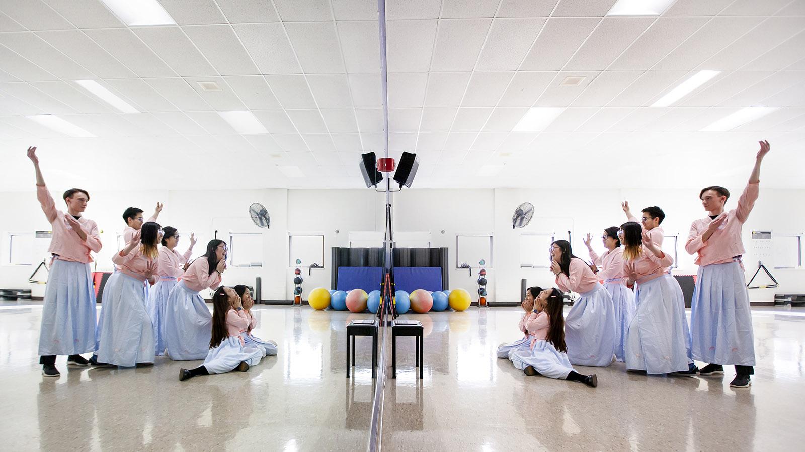 Members of the Chinese Students Association rehearse in front of a mirror for their portion of Cabaret in the Wellness Center Multipurpose Room.