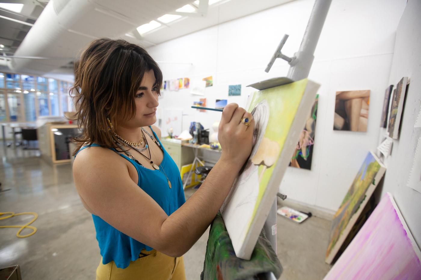 Marifé Entenza-Sierra, a studio art major at Lawrence, works on her oil painting in Wriston Art Center.