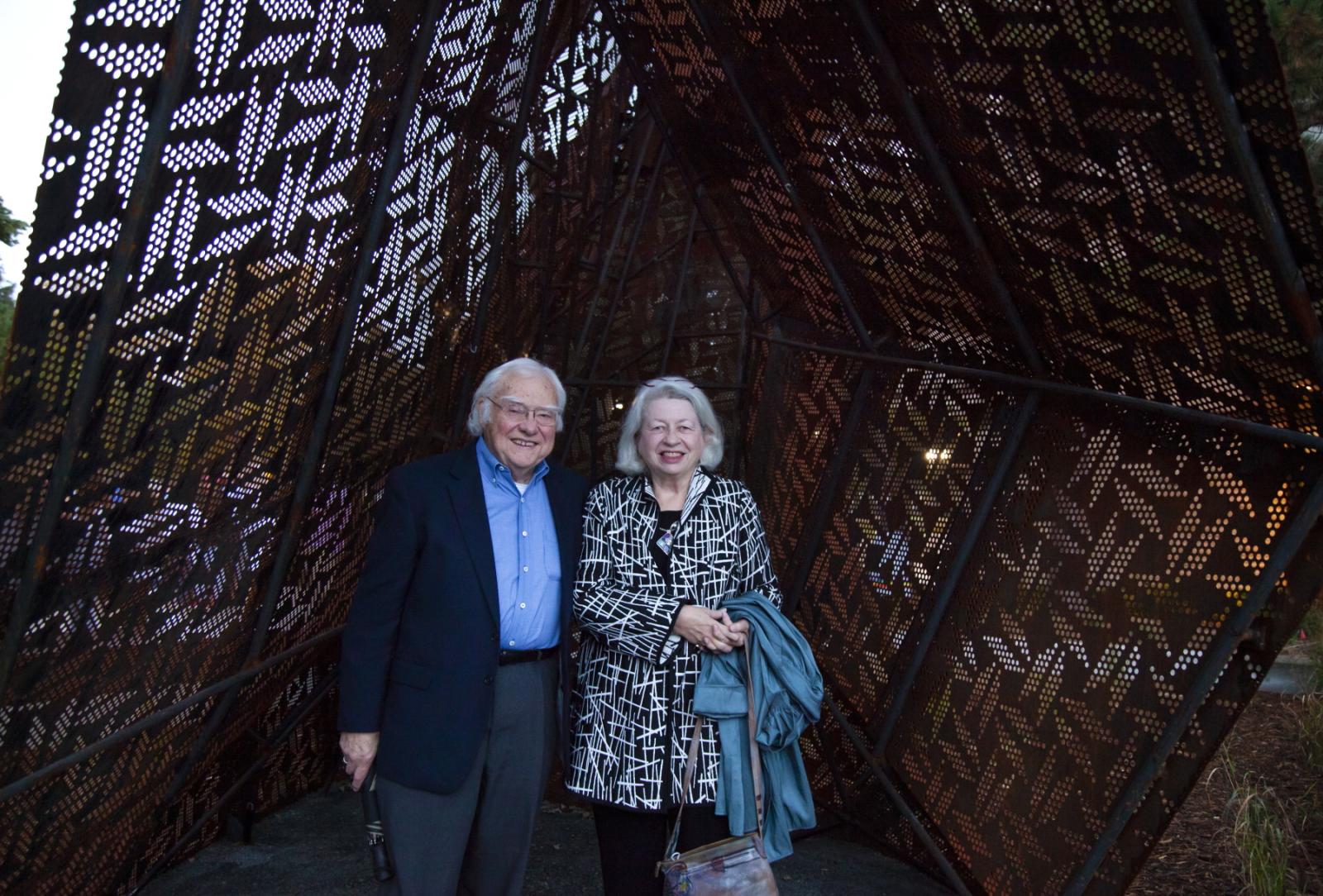 Robert and Patricia Anker stand for a portrait inside the new sculpture on campus in 2021.