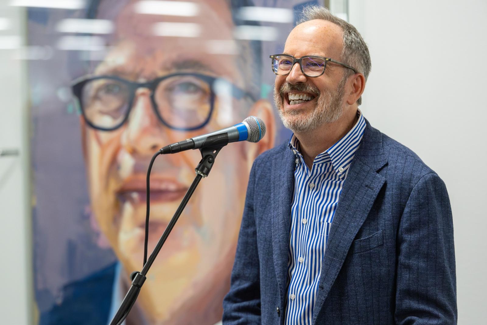 Former President Mark Burstein speaks in front of his presidential portrait in the Center for Academic Success in Mudd Library.