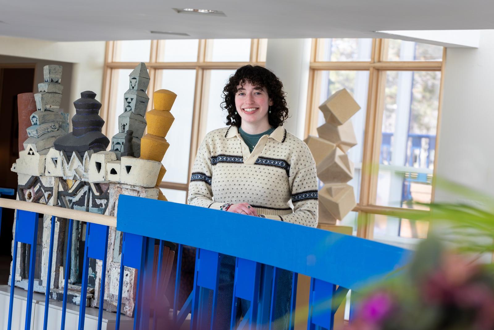 Senior Maddy Tevonian poses for a photo in the Wriston Art Center.