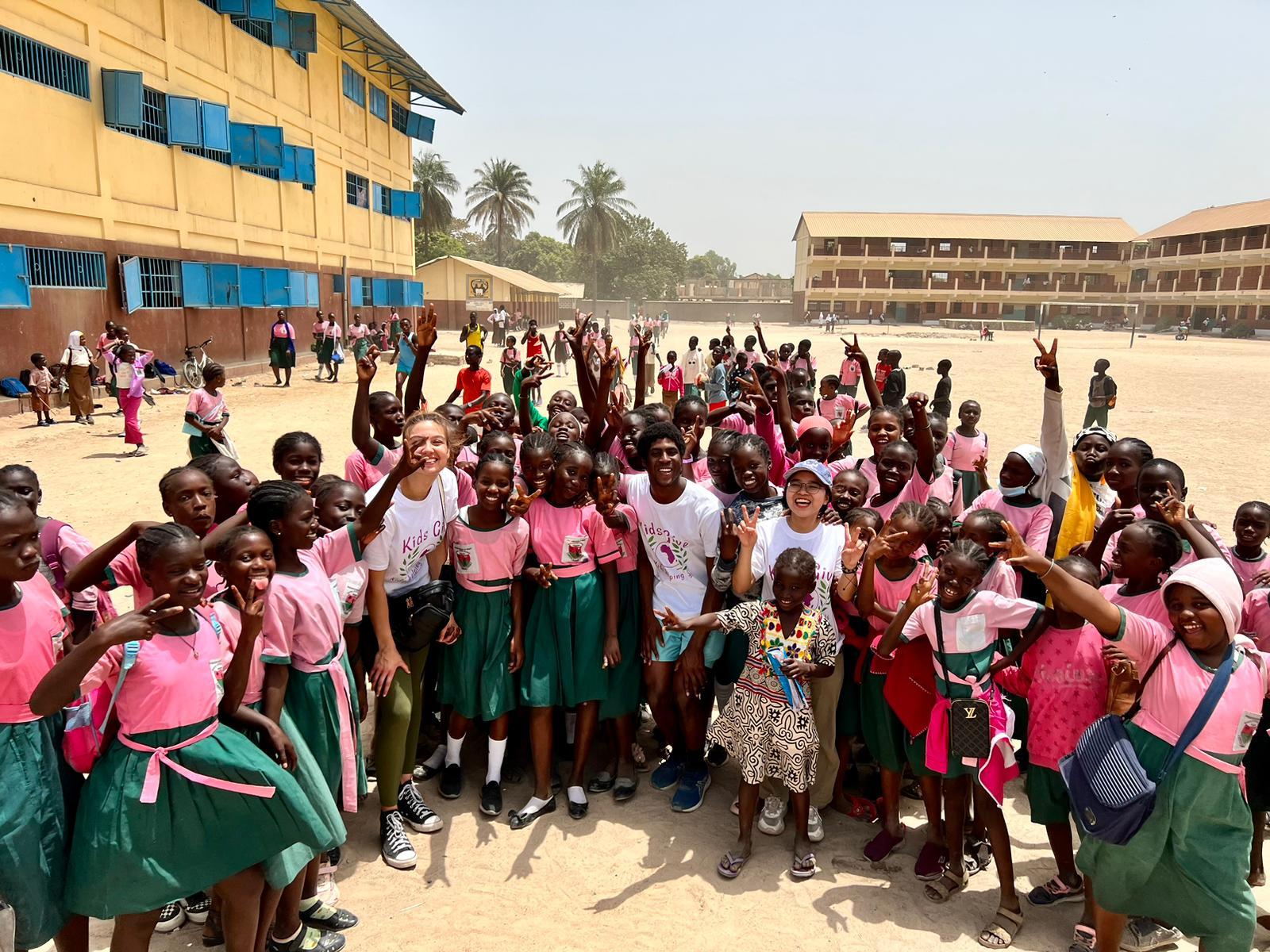 Lawrence students interact with students in a schoolyard in The Gambia.
