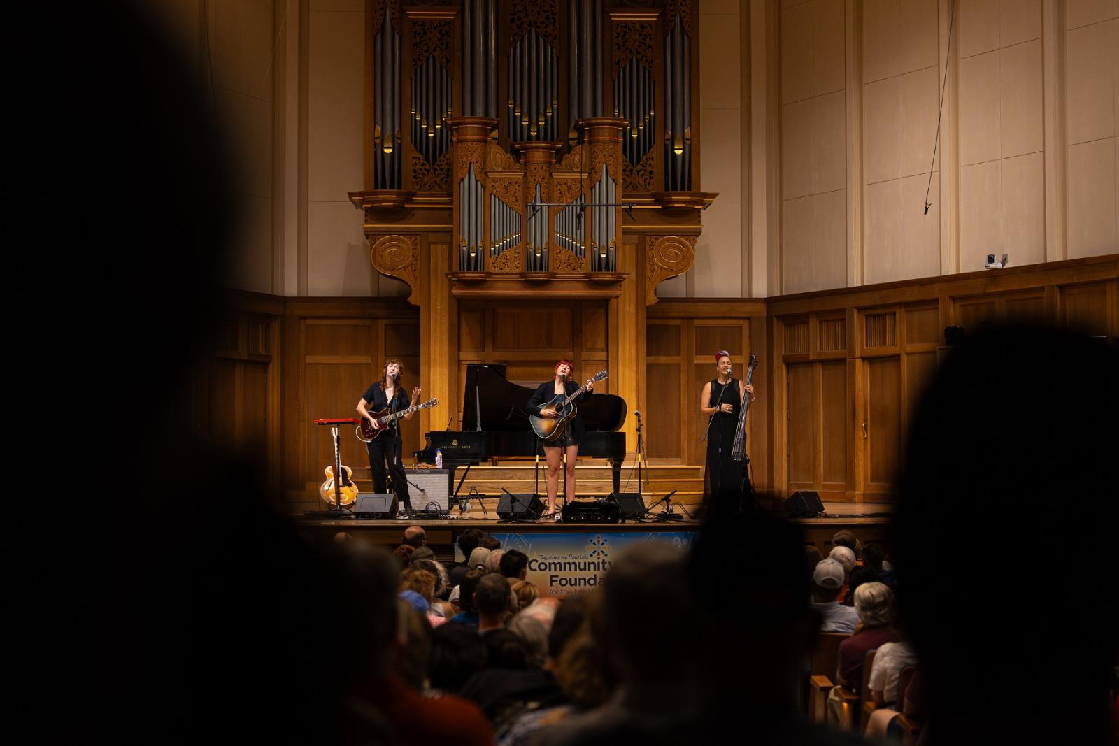 A music trio performs on stage at Memorial Chapel during Mile of Music.