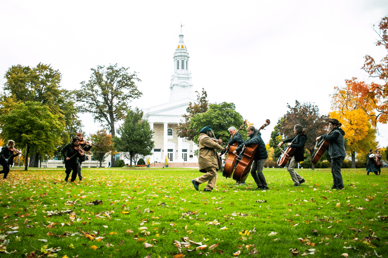 People play instruments outside in front of Lawrence Chapel