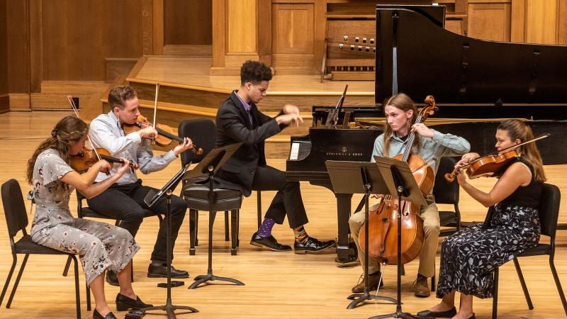 Decoda Lawrence Music Camp High School chamber students performing on stage in Memorial Chapel