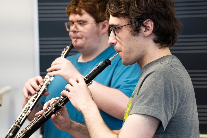 Two students playing oboes.
