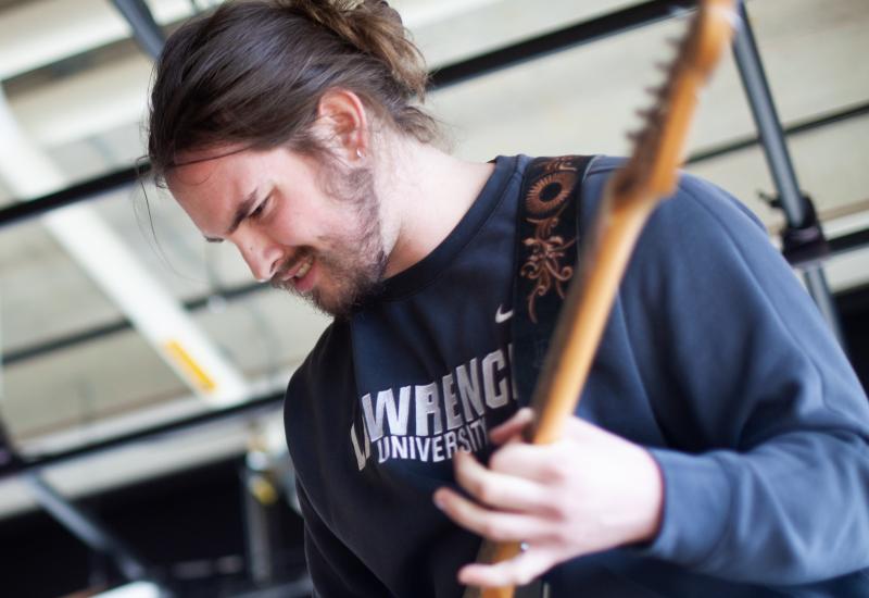 Michael Murphy performs at EarthFest in Warch Cinema. Students like Michael who are business and entrepreneurship majors and music performance majors, study entrepreneurship in college, and earn a business and entrepreneurship degree, while building their own business. (Photo by Danny Damiani)