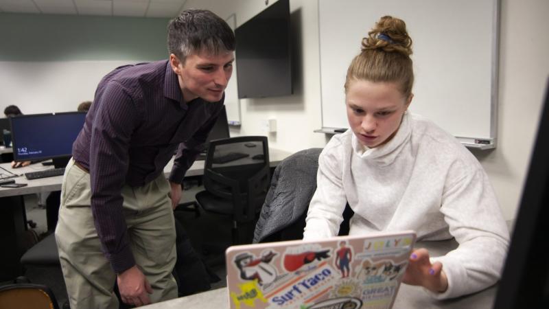 Andrew Sage, assistant professor of statistics, works with Erin Lengel, a computer science degree student, in a Data-Scientific Programming class during Winter Term. 