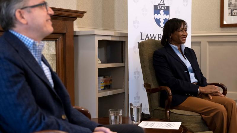Mark Burstein and President Laurie Carter sitting next to each other as they smile for a picture