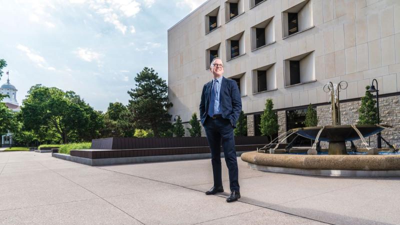 Hero shot of Mark Burstein next to the water fountain located near the Mudd library 