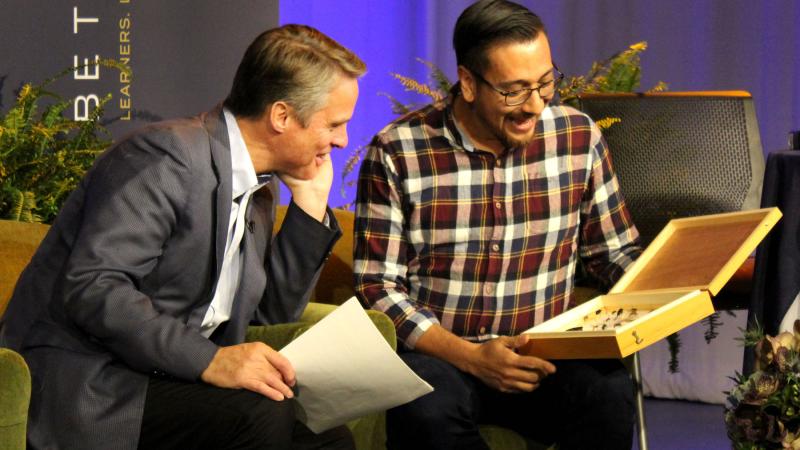 Terry Moran ’82 (left) shares a moment with biology professor Israel Del Toro during the 2019 Giving Day 