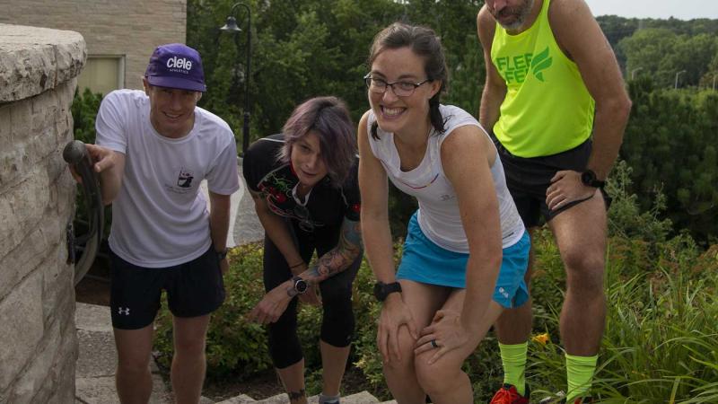 Four Lawrence faculty members posing for a photo while wearing running attire