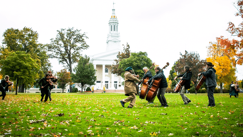 People play instruments outside in front of Lawrence Chapel
