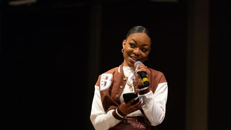 A student sings on stage.