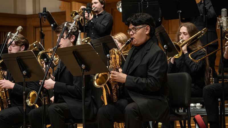 Saxophonists playing in a jazz big band.