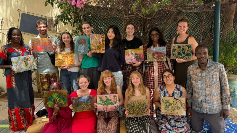 Students following a painting class with a famous Senegalese Artist