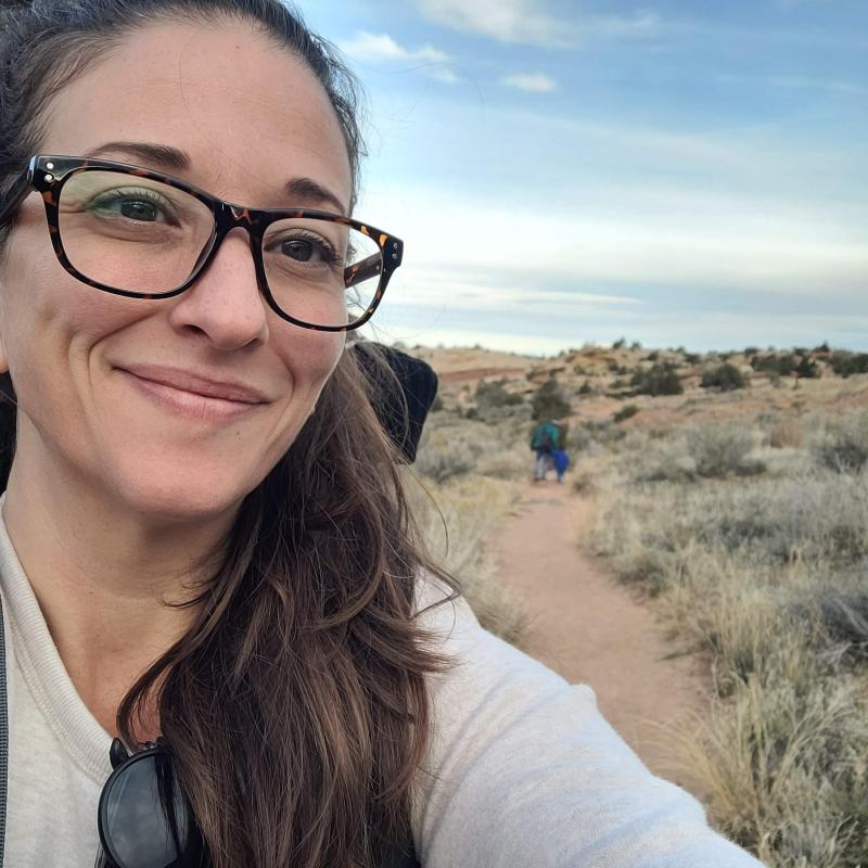 Female smiling, desert in background