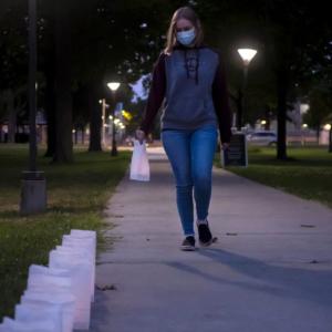 Student walking down Main green towards Handshake event