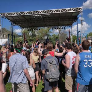 Students dancing in front of a stage while musicians perform.