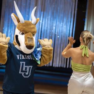 Blu dances with students at the Homecoming dance.