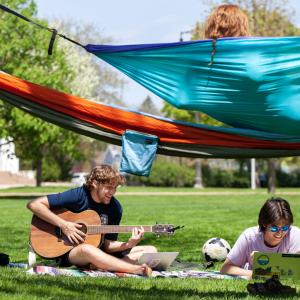 Duval Bingham and Aki Grill, both juniors, enjoy Main Hall Green on a sunny day in Spring Term. 